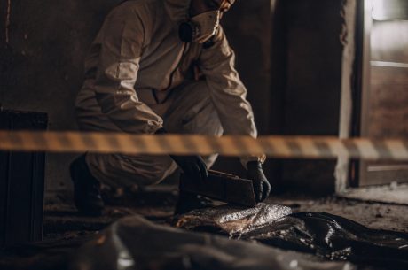 Professional performing biohazard cleanup in a rental property, illustrating landlord cleanup responsibilities under Alexandria biohazard cleanup laws..