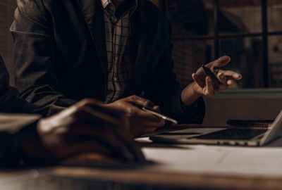 Professionals reviewing documents and discussing a homeowners insurance claim for biohazard cleanup costs