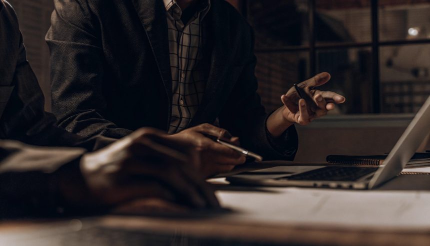 Professionals reviewing documents and discussing a homeowners insurance claim for biohazard cleanup costs