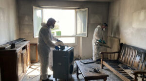 Fire restoration technicians use air filtration and deodorization equipment to remove smoke odors from a fire-damaged home in Alexandria.