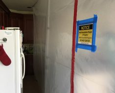 Mold Remediation Warning signs posted on containment.