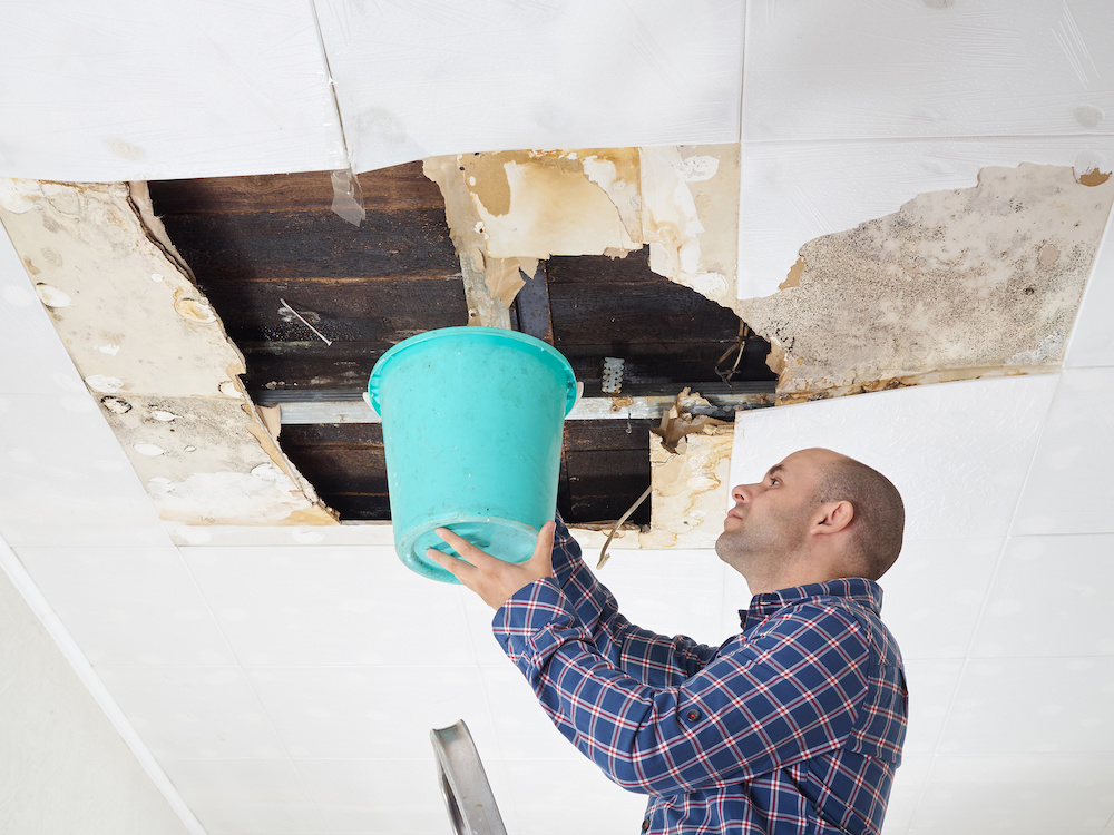 A man dealing with a leaky roof