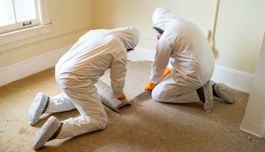 Two workers from a restoration company in Atlanta help mitigate damage in a home