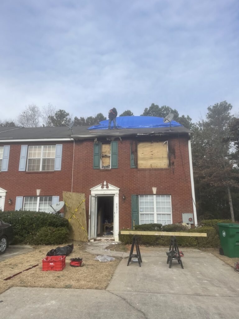 The fire-damaged home had to be tarped and boarded up as protective measures against the elements.