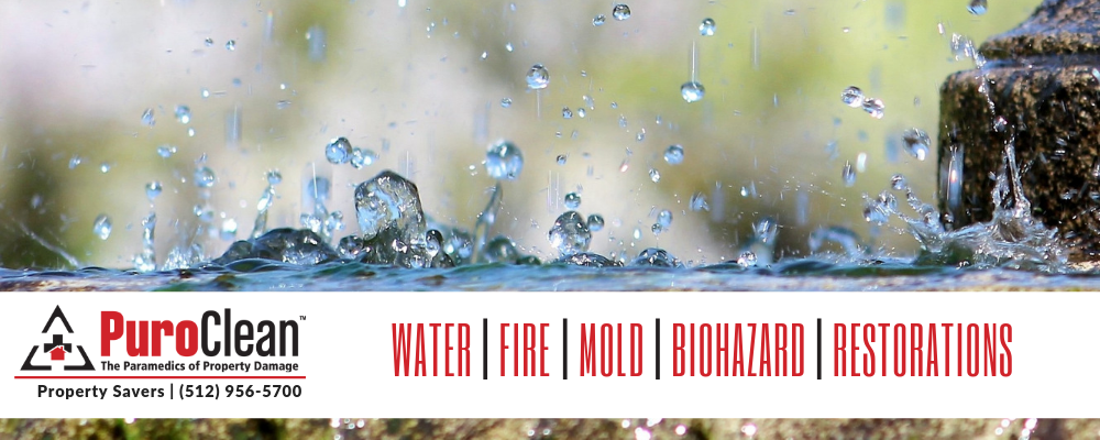 Water splashing from a stone surface, highlighting the importance of property protection before a hurricane.