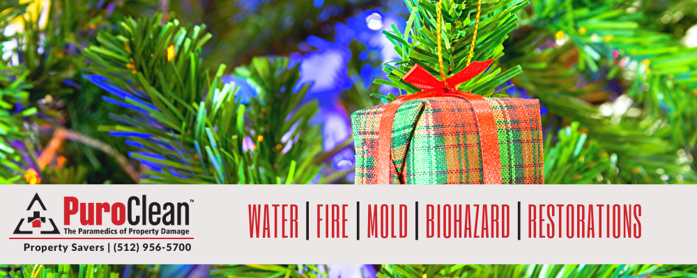A festive Christmas tree with a wrapped gift, featuring PuroClean's restoration services banner.