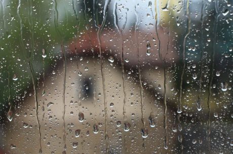 Looking out window at rain dripping down. Spring storm preparedness is key this time of year.