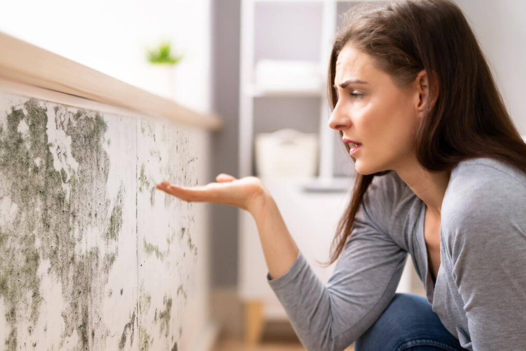 Shocked woman looking at mold
