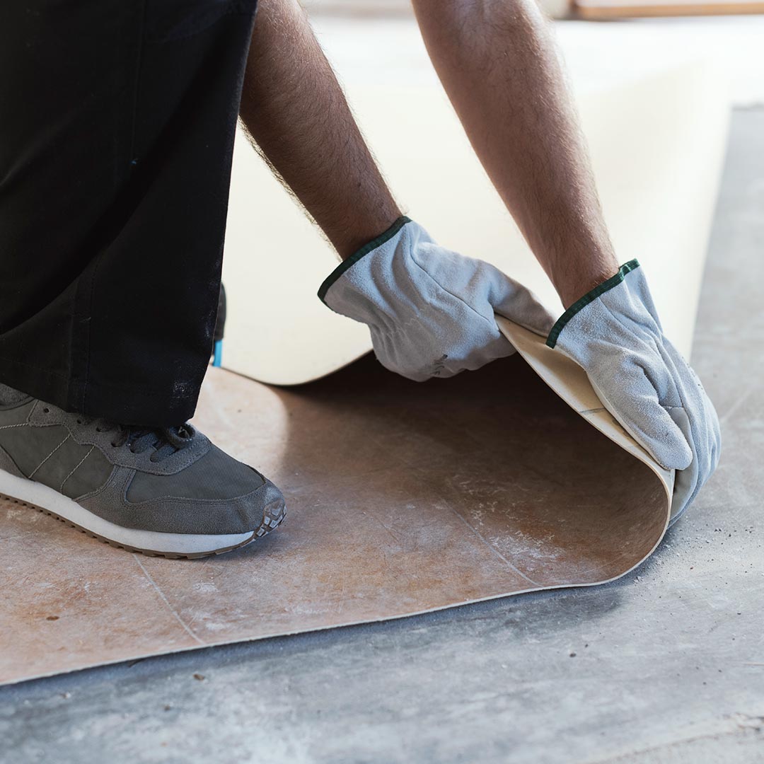 man replacing linoleum flooring