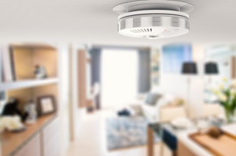 Smoke detector on ceiling. Choosing the best of the smoke detector types can protect your home and family.