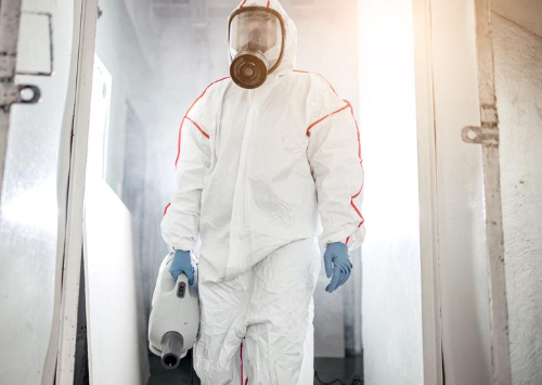 Certified biohazard cleanup Bradenton FL technician in full PPE removing hazardous waste