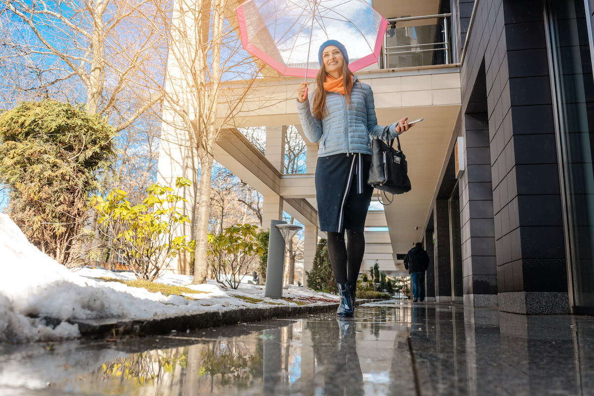 woman with umbrella spring thaw commercial restoration services