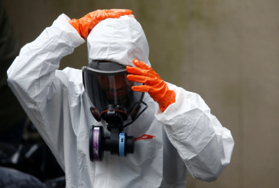 Certified trauma cleanup services Bradenton technician in full PPE removing biohazardous materials