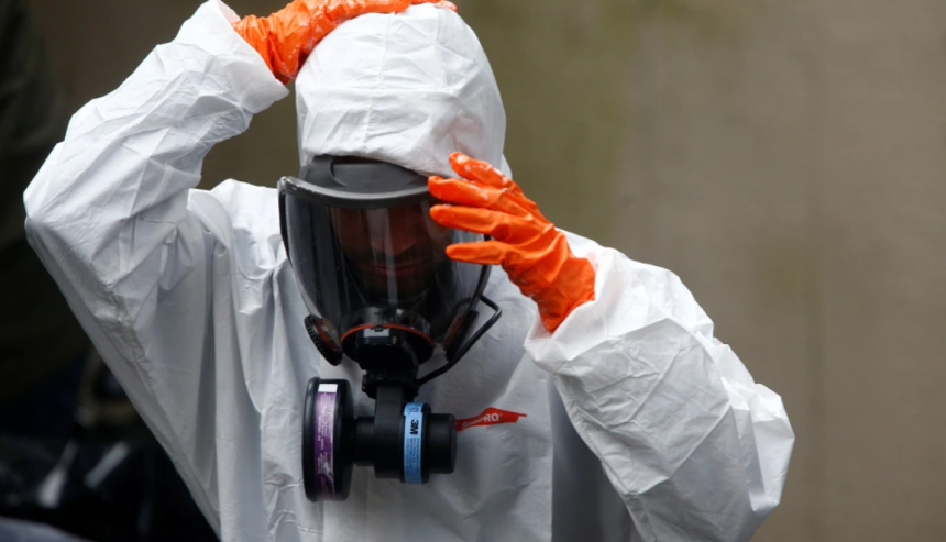 Certified trauma cleanup services Bradenton technician in full PPE removing biohazardous materials