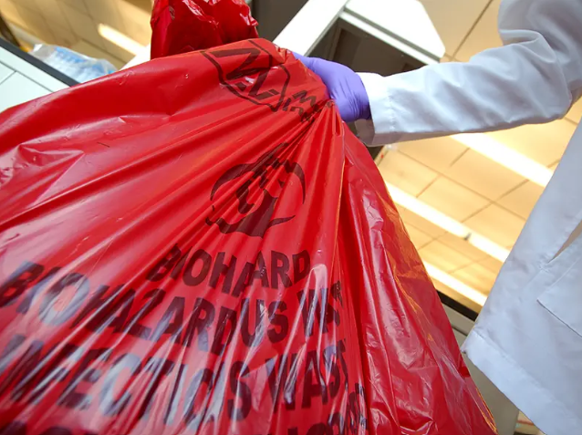 biohazard technician performing after death house cleaning by removing contaminated materials safely