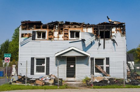 Exterior of a fire-damaged home in Atlanta showing structural and smoke damage