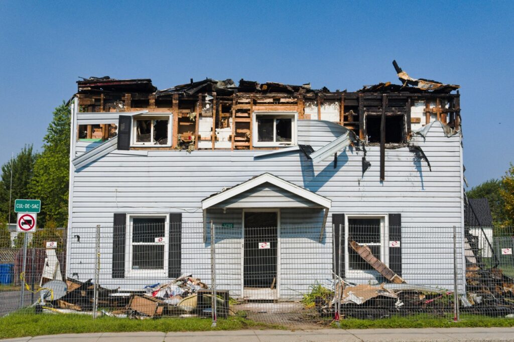 Exterior of a fire-damaged home in Atlanta showing structural and smoke damage