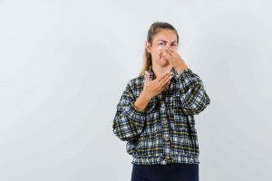 young-female-pinching-nose-due-bad-Mold smell