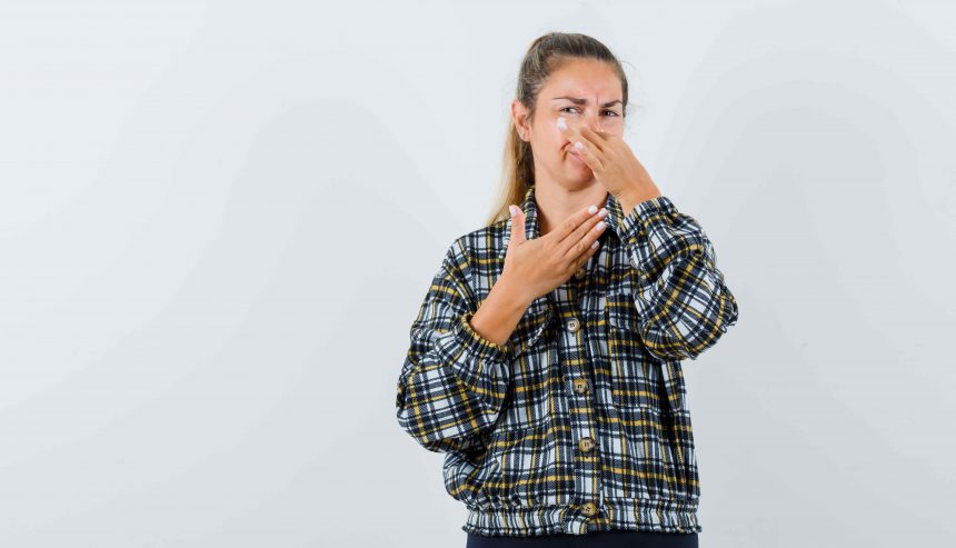 young-female-pinching-nose-due-bad-Mold smell