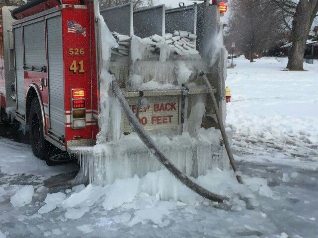 Frozen fire truck covered in ice during Atlanta cold weather alert, symbolizing freezing temperatures and burst pipe risks.