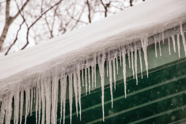 Ice dams forming on roof can cause roof leak water damage