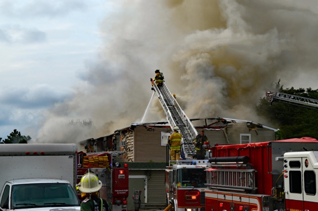 Firefighters extinguishing roof fire at home in Fulton County Georgia