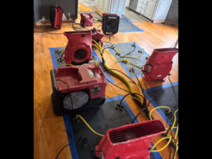 Drying equipment in place as part of a home water damage restoration process, helping remove excess moisture and support proper drying inside a residential space.