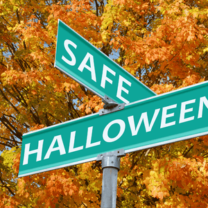 Two green street signs reading 'SAFE' and 'HALLOWEEN' are displayed