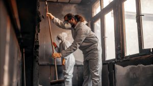 Restoration professionals cleaning smoke and soot during fire damage restoration in Apex NC to repair and restore residential property