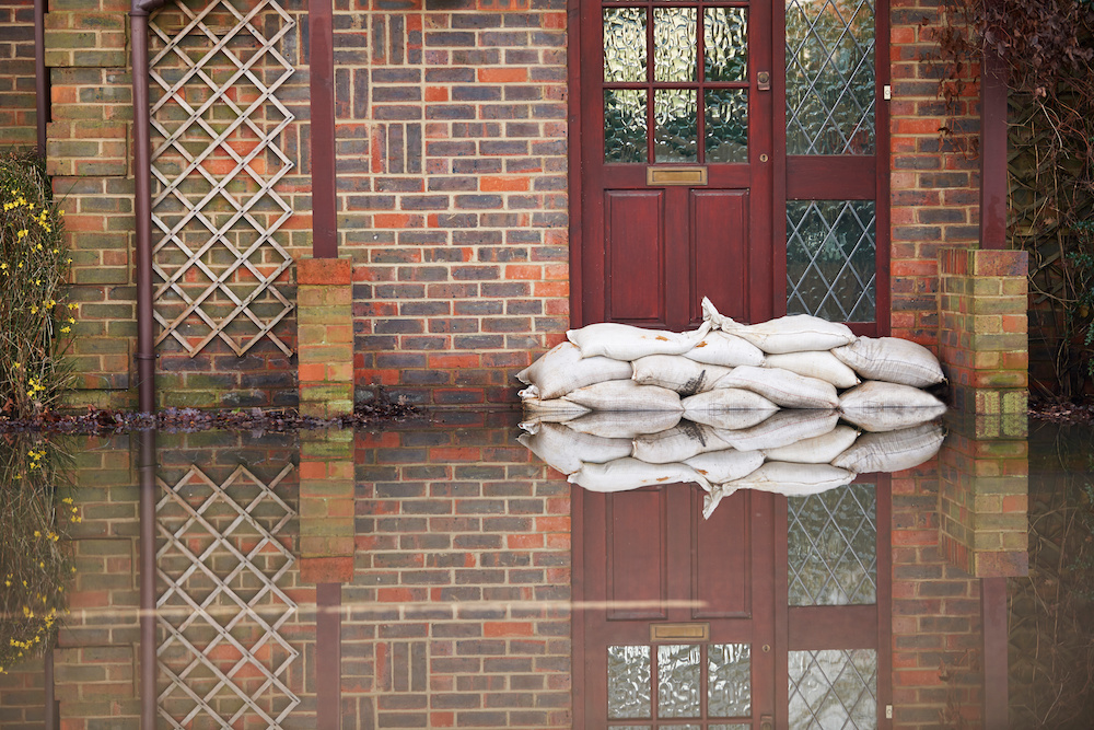 sand bags in front of a flooded home during spring flooding