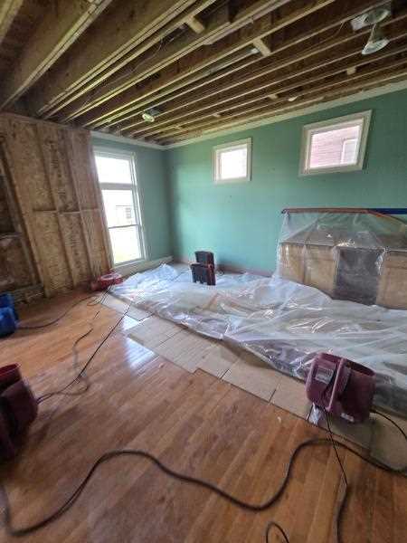 Air movers and containment setup during storm damage repair in St. Louis after tornado water intrusion.