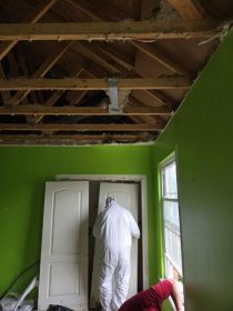 Structural demolition and cleanup were performed safely using containment barriers and protective equipment.