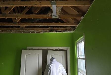 Structural demolition and cleanup were performed safely using containment barriers and protective equipment.