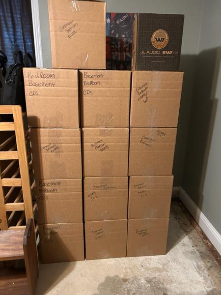 Labeled boxes organized for on-site storage during sump pump failure cleanup in Edwardsville, IL home.