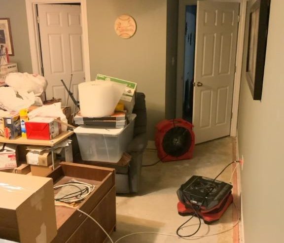 Drying equipment and air movers placed in a basement during sump pump failure cleanup and water damage restoration in Edwardsville, IL.