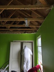 Structural demolition and cleanup were performed safely using containment barriers and protective equipment.