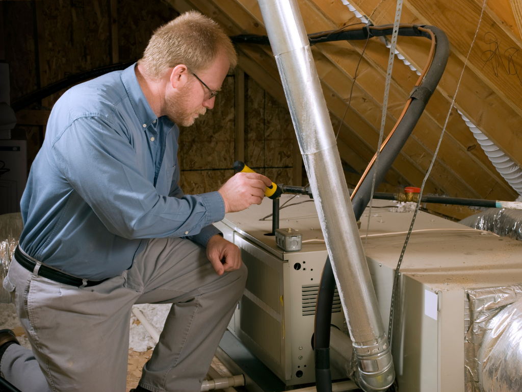 Technician checking attic appliances