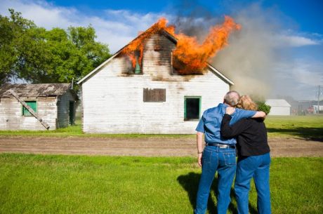 couple watching their house catch on fire