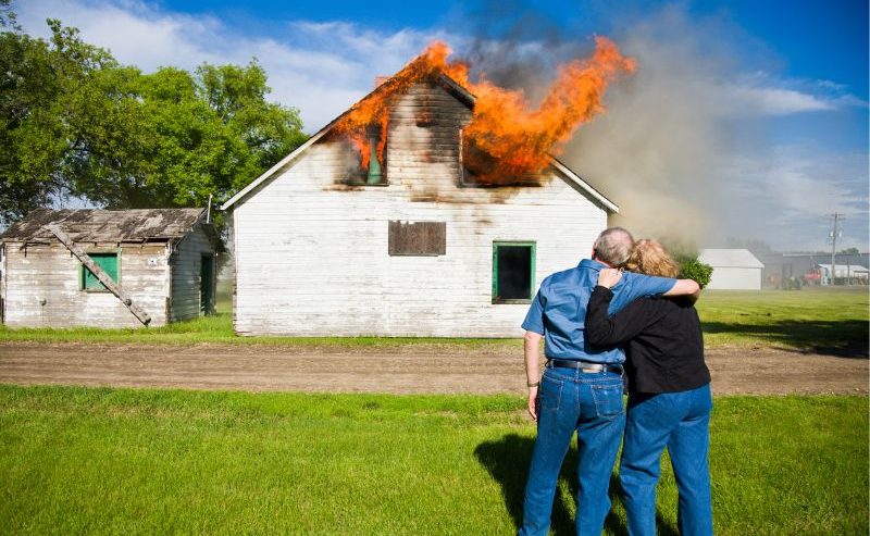couple watching their house catch on fire