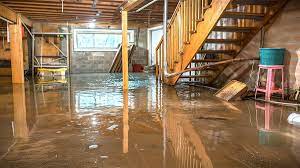 Flooded basement with standing water and damaged furniture