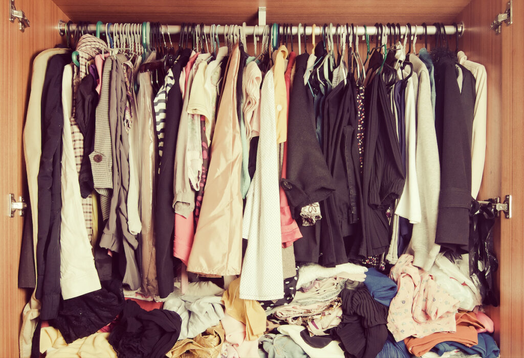 Pile of messy clothes in closet. Hoarding
