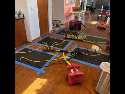 Drying equipment in place as part of a home water damage restoration process, helping remove excess moisture and support proper drying inside a residential space.
