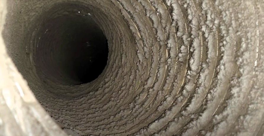 Close-up of a dirty air vent with visible dust and debris