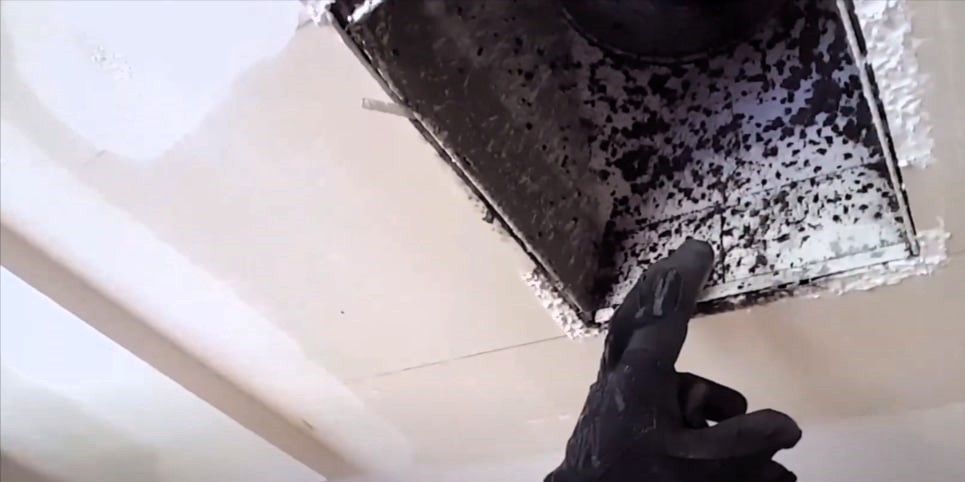 Technician inspecting ductwork for signs of mold and moisture