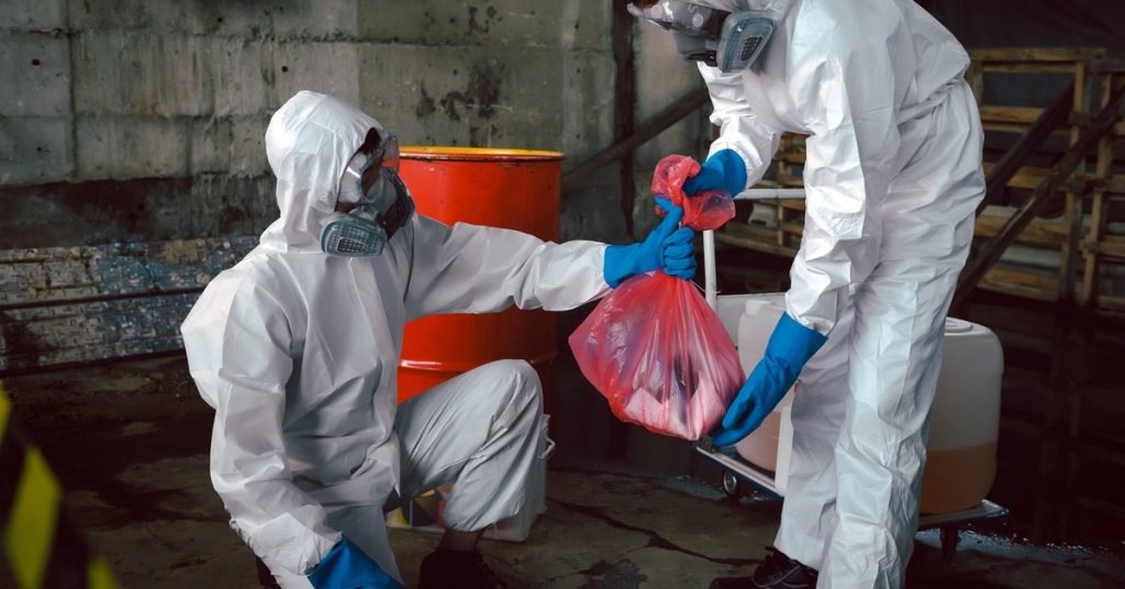 biohazard cleanup team establishing a secure containment area in a residential building
