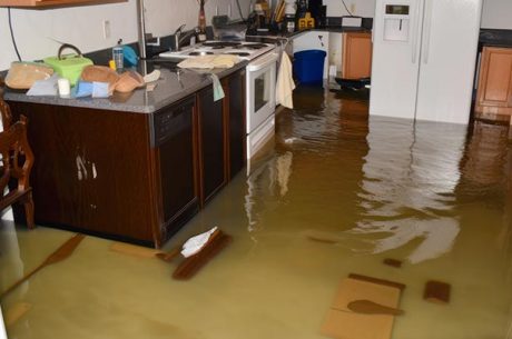 flood damage restoration team using industrial equipment to dry a flooded Covington LA home