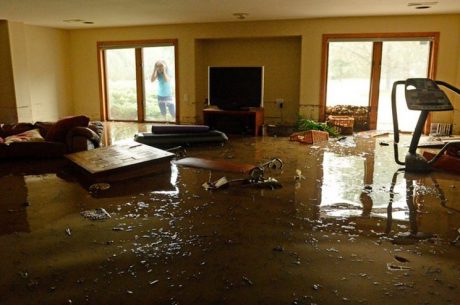 water damage restoration team extracting water from a flooded Covington LA home