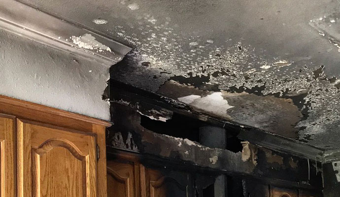 fire damage restoration professionals assessing smoke soot damaged interior home Louisiana