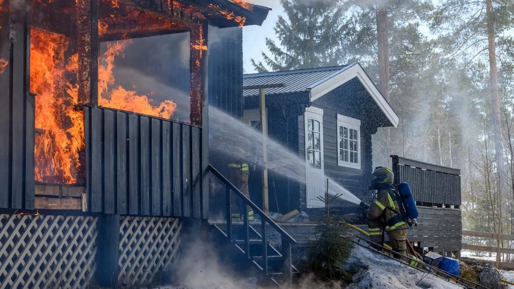 Firefighters responding to a storm-ignited residential fire in Louisiana with significant water and smoke damage to the roof and attic