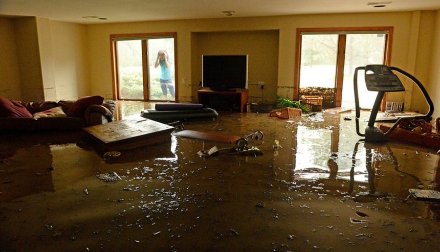 water damage restoration team extracting water from a flooded Covington LA home